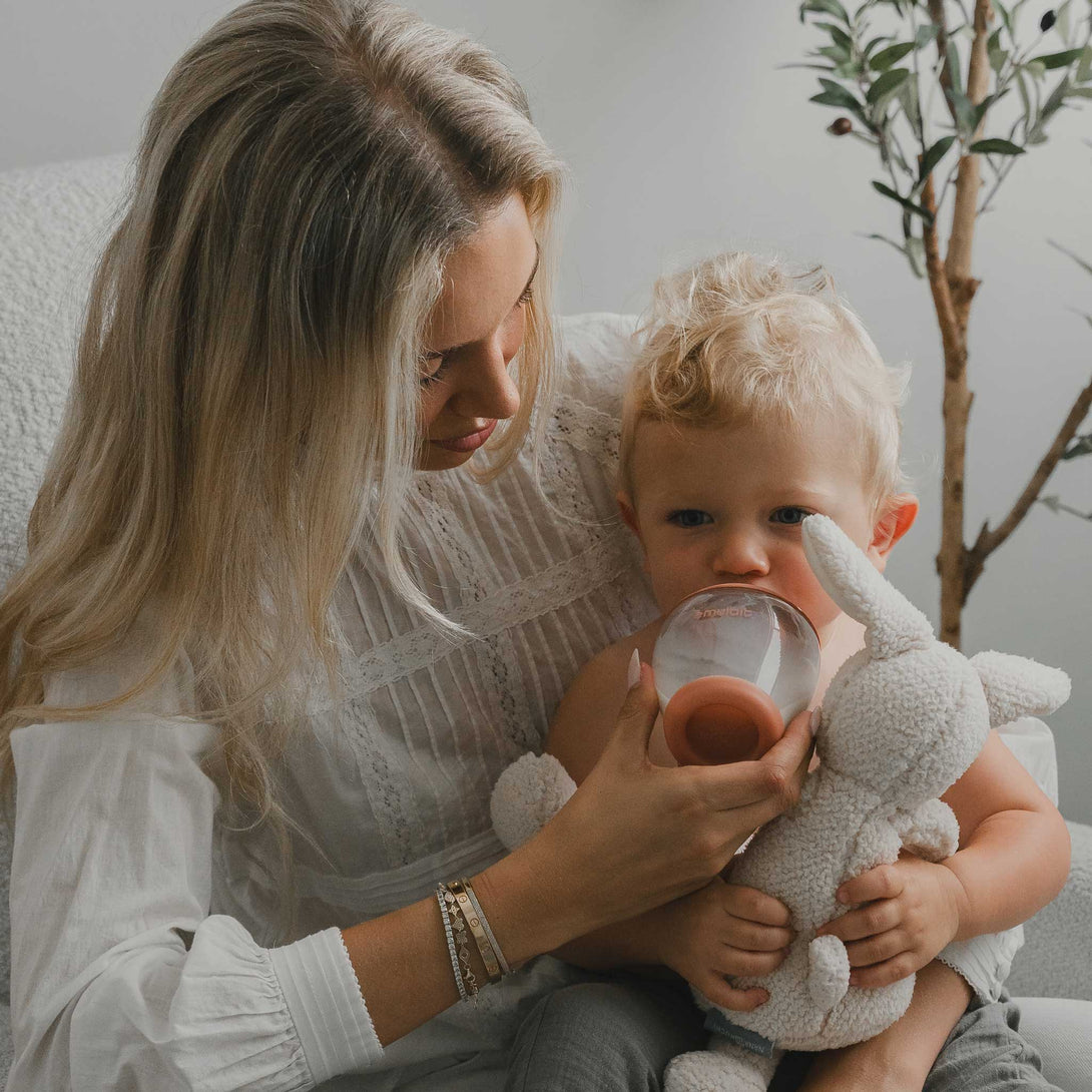 Mother holding baby with Emulait Classic Bottle