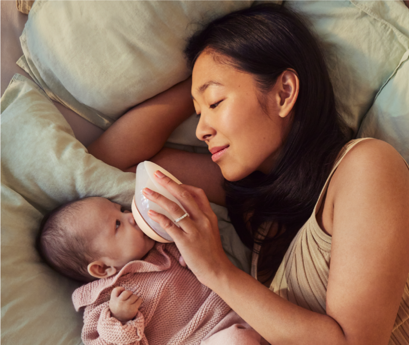 Mom nursing baby using Emulait Anatomy Bottle